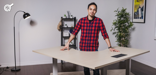 A man next to an ergonomic L-shaped standing desk