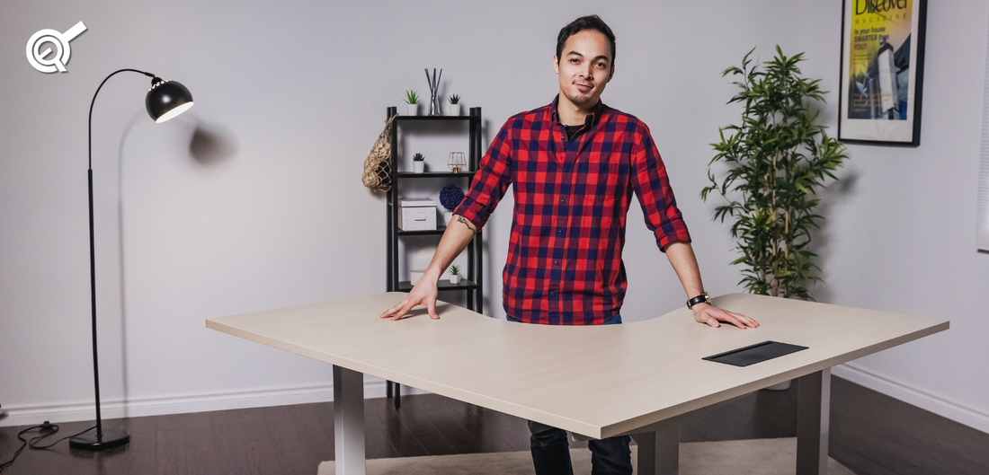 A man next to an ergonomic L-shaped standing desk 